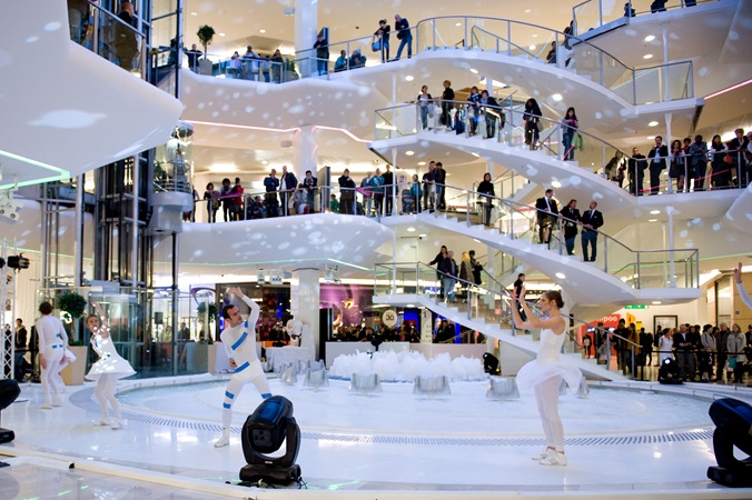 A show entertains customers around the main fountain of Westfield La Part-Dieu shopping centre